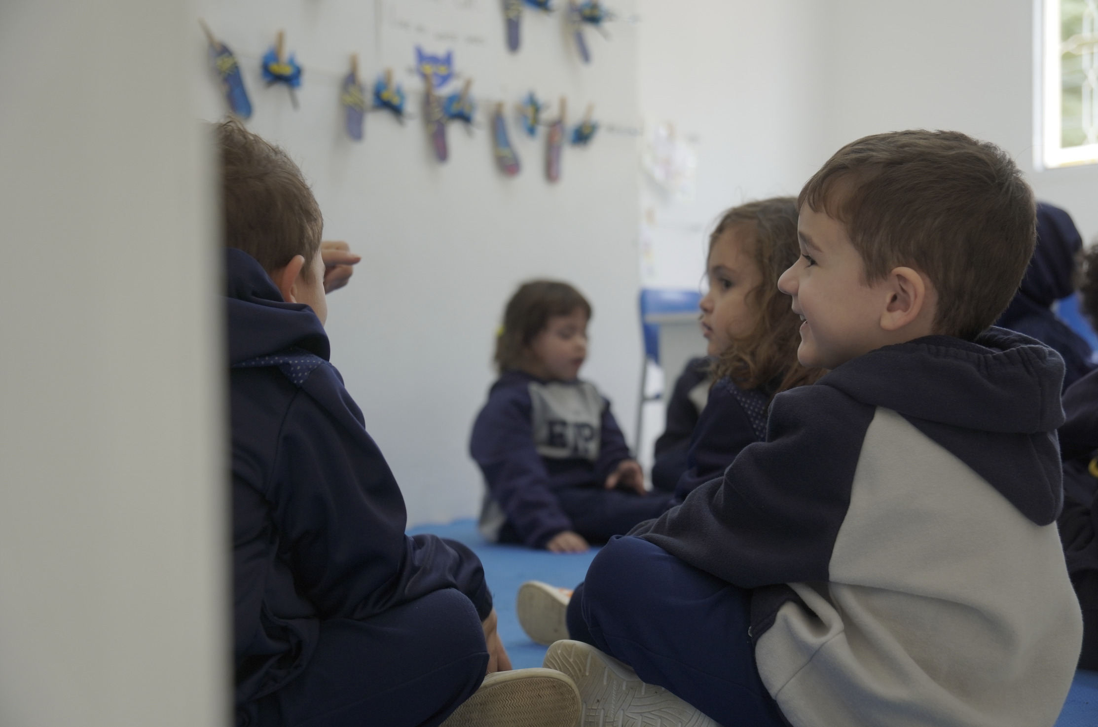 Photo of rows of books in a library with marble busts.