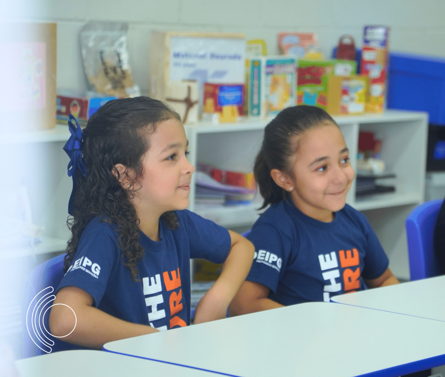 Photo of rows of books in a library with marble busts.
